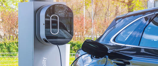 Socket plug with charging for electric car, battery charging close up view. Gas electricity station